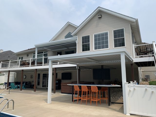 A large house with a patio and table.