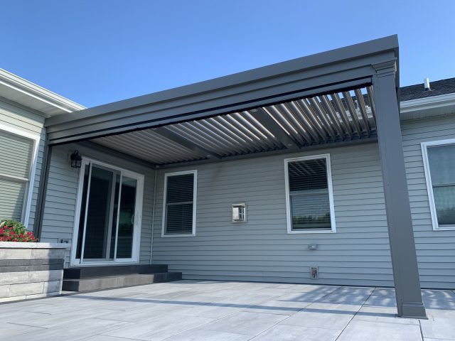 A patio with an awning over the top of it.