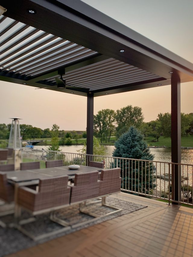 A patio with an open roof and a table