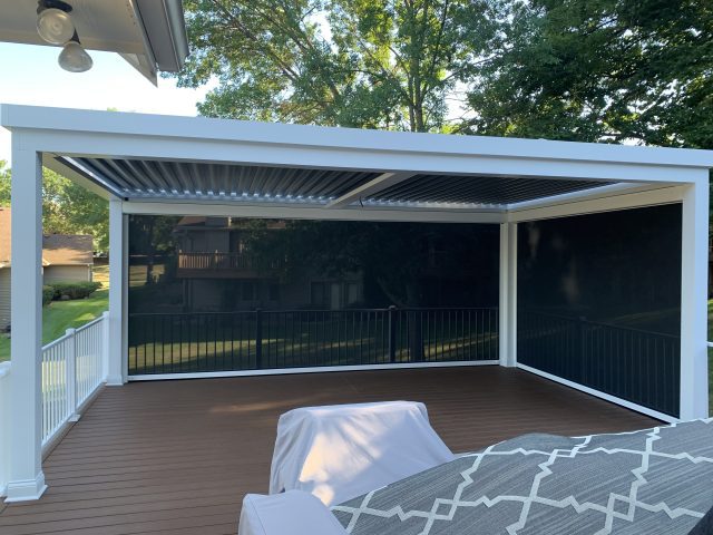 A bed sitting on top of a wooden deck.