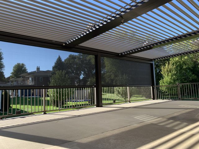 A patio with a pergola and a fence