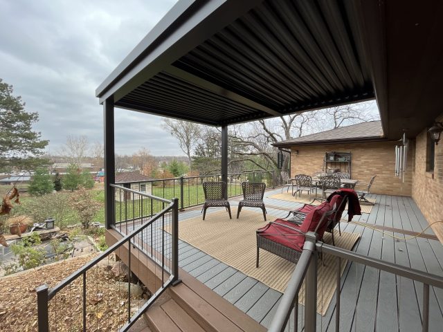 A deck with chairs and tables on it