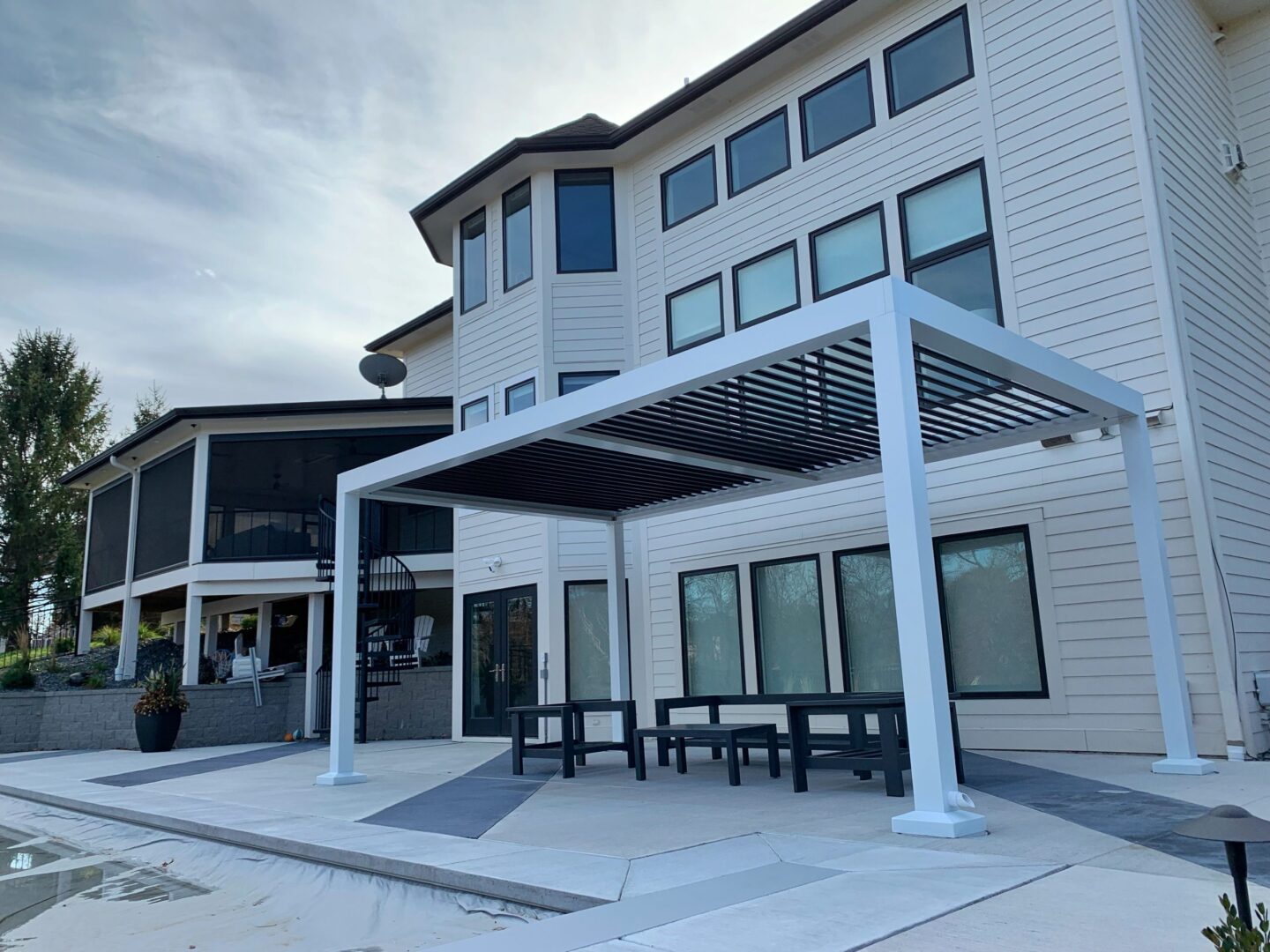 A patio with tables and chairs outside of a building.