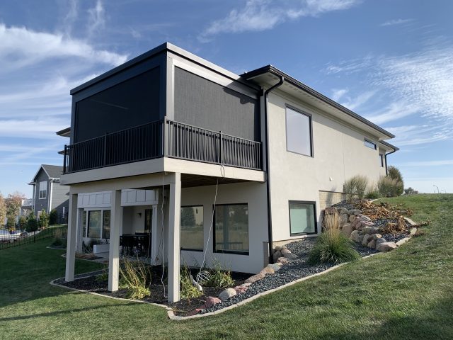 A house with a balcony and steps leading to the front.