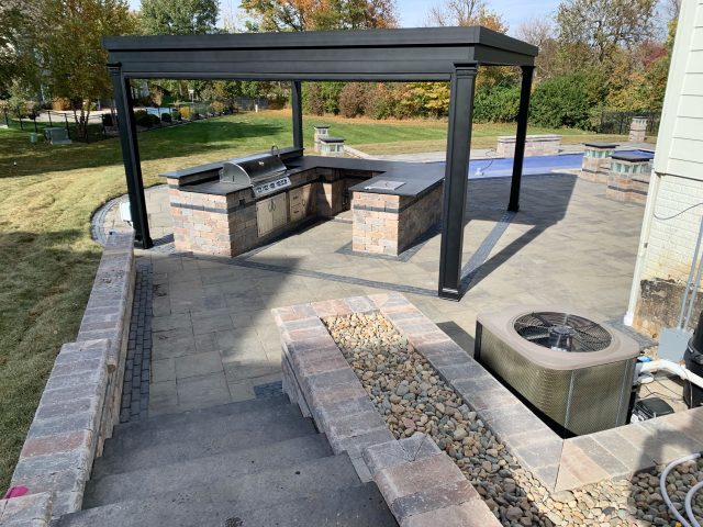 A large outdoor grill area with fire pit and seating.