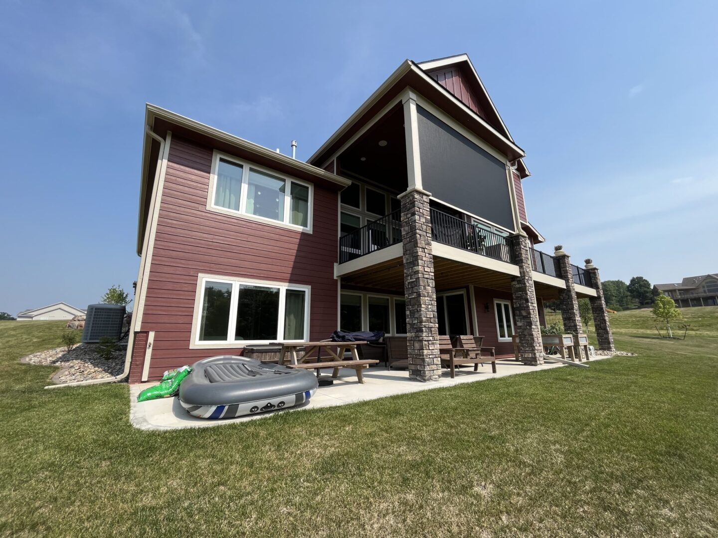 A large red house with a car parked in front of it.