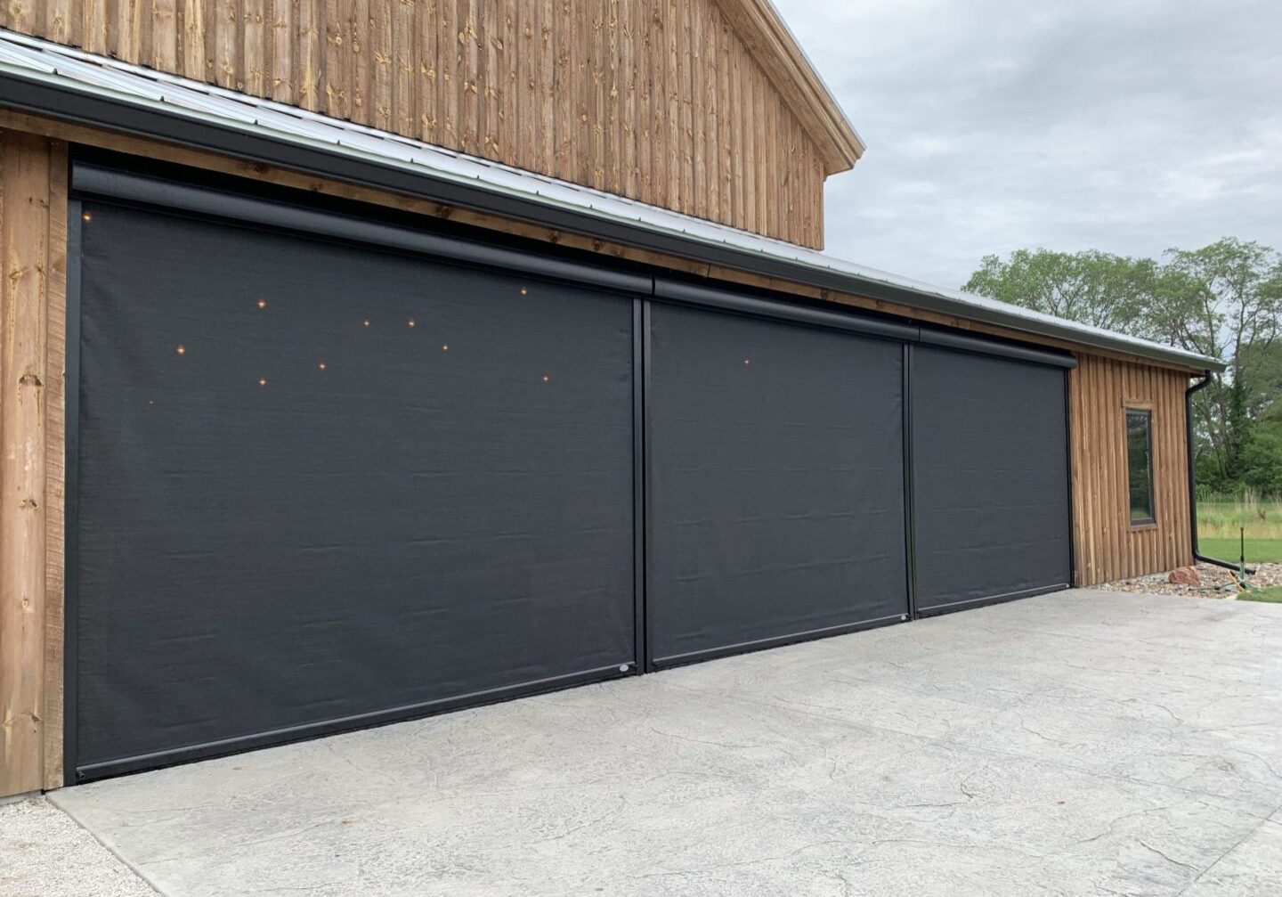 A garage door that has been opened up to let in the sun.