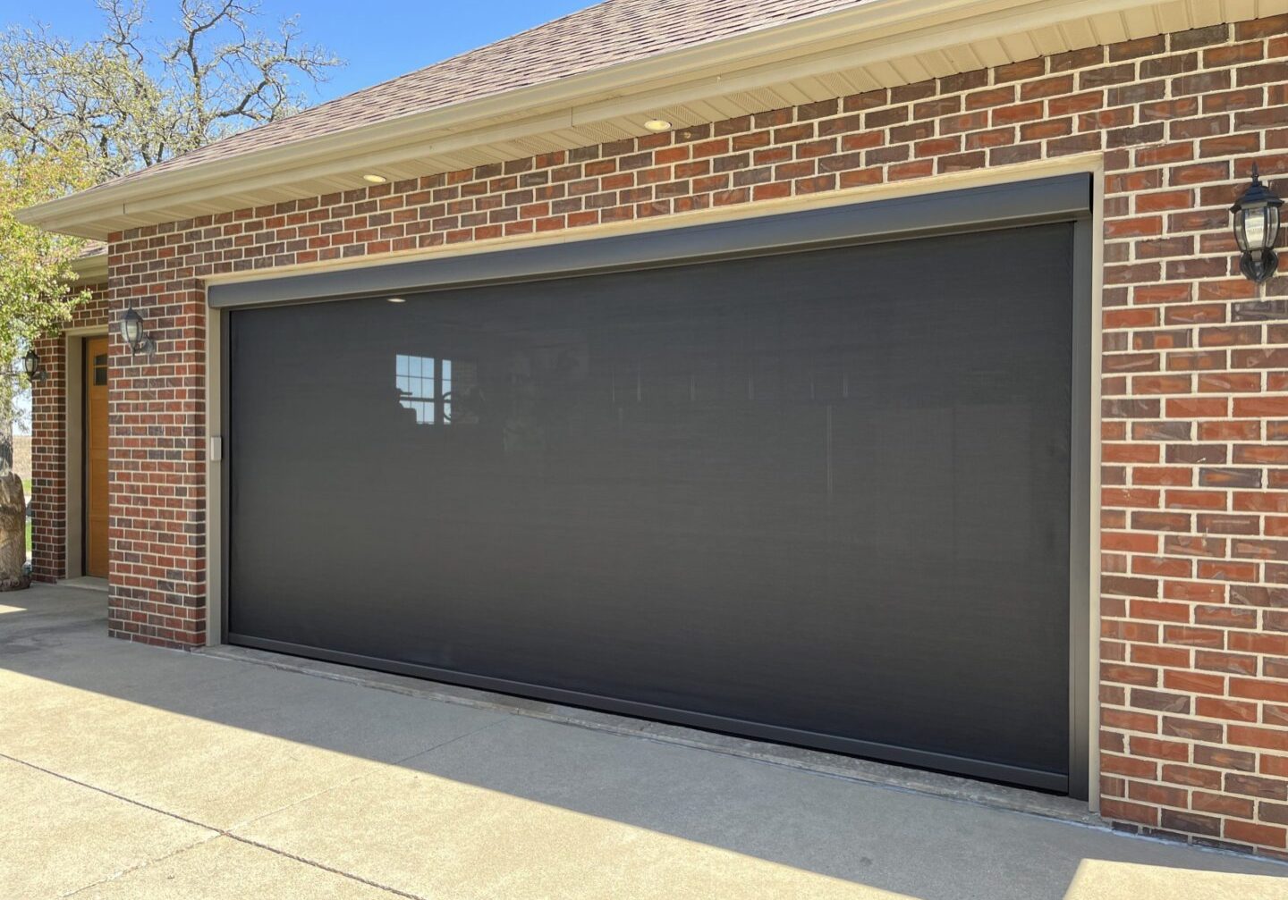 A garage door that is closed and black.